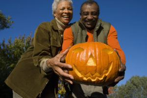 Elderly couple holding a jack-o-lantern